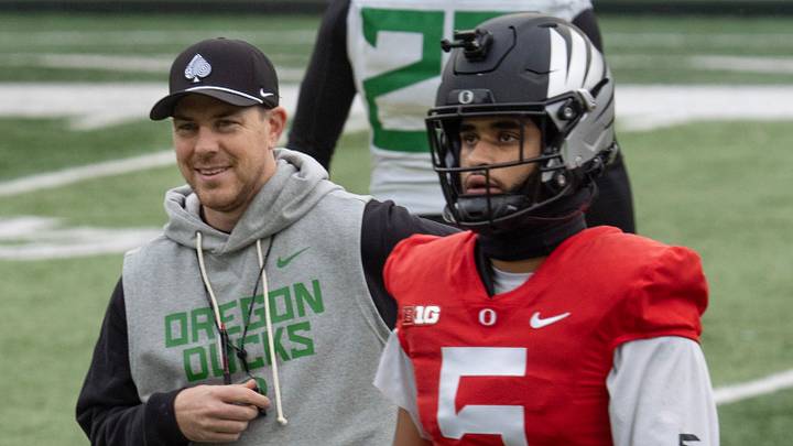 Oregon Offensive Coordinator Will Stein leads a drill with quarterback Dante Moore at Autzen Stadium in Eugene Dec. 14, 2025 before the first-round CFP game against James Madison.