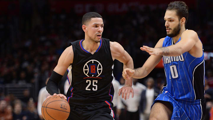 Los Angeles Clippers guard Austin Rivers dribbles the ball as Orlando Magic forward Evan Fournier defends. Mandatory Credit: Robert Hanashiro-Imagn Images