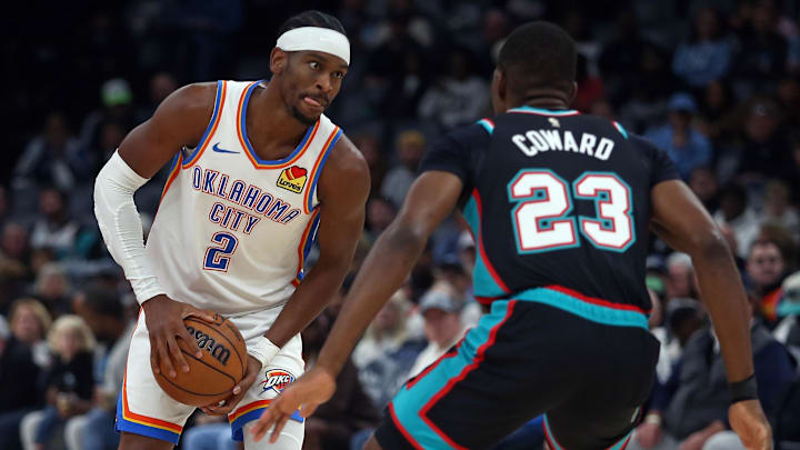 Nov 9, 2025; Memphis, Tennessee, USA; Oklahoma City Thunder guard Shai Gilgeous-Alexander (2) handles the ball as Memphis Grizzlies forward Cedric Coward (23) defends during the first quarter at FedExForum. Mandatory Credit: Petre Thomas-Imagn Images