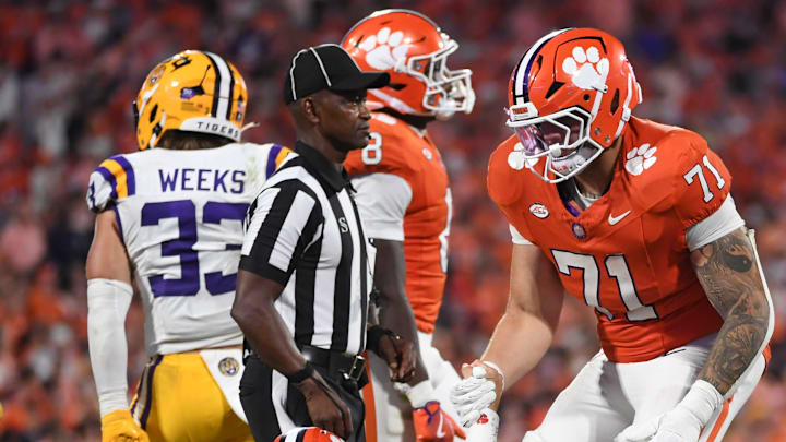 Clemson Tigers offensive lineman Tristan Leigh (71) helps up Clemson Tigers quarterback Cade Klubnik (2) Saturday, Aug. 30, 2025 during the NCAA football game against the LSU Tigers at Memorial Stadium in Clemson, South Carolina. LSU Tigers won 17-10.