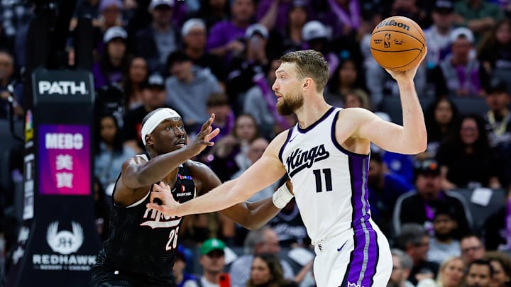 Mar 27, 2025; Sacramento, California, USA; Sacramento Kings forward Domantas Sabonis (11) controls the ball against Portland Trail Blazers center Duop Reath (26) during the third quarter at Golden 1 Center. Mandatory Credit: Sergio Estrada-Imagn Images