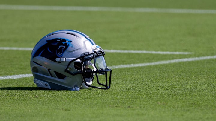 A Carolina Panthers helmet sits on the ground at training camp