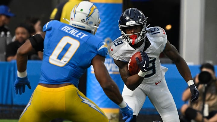 Nov 10, 2024; Inglewood, California, USA; Tennessee Titans wide receiver Jha'Quan Jackson (19) heads down the field as Los Angeles Chargers linebacker Daiyan Henley (0) moves in to make the stop during the second quarter at SoFi Stadium. Mandatory Credit: Robert Hanashiro-Imagn Images
