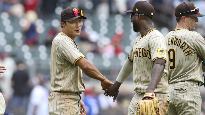 May 15, 2022; Atlanta, Georgia, USA; San Diego Padres second baseman Ha-Seong Kim (7) and left fielder Jurickson Profar (10) celebrate after a victory against the Atlanta Braves at Truist Park. Mandatory Credit: Brett Davis-Imagn Images