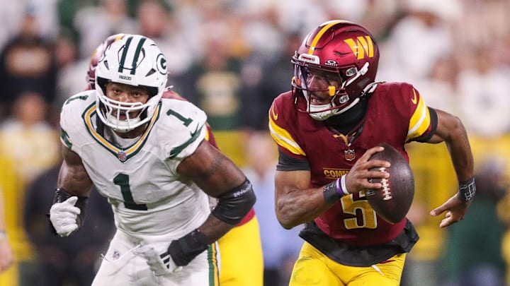 Washington Commanders quarterback Jayden Daniels (5) scrambles away from Green Bay Packers defensive end Micah Parsons (1) on Thursday, September 11, 2025, at Lambeau Field in Green Bay, Wis. The Packers won the game, 27-18.
Tork Mason/USA TODAY NETWORK-Wisconsin