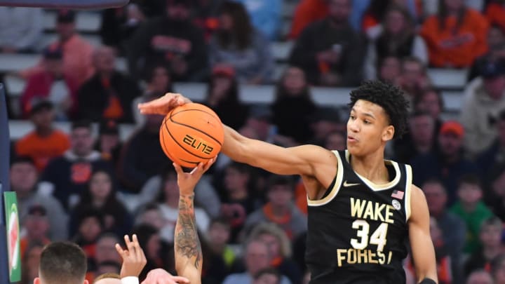 Mar 4, 2023; Syracuse, New York, USA; Wake Forest Demon Deacons forward Bobi Klintman (34) blocks a shot by Syracuse Orange guard Judah Mintz (3) in the first half at JMA Wireless Dome. Mandatory Credit: Mark Konezny-USA TODAY Sports