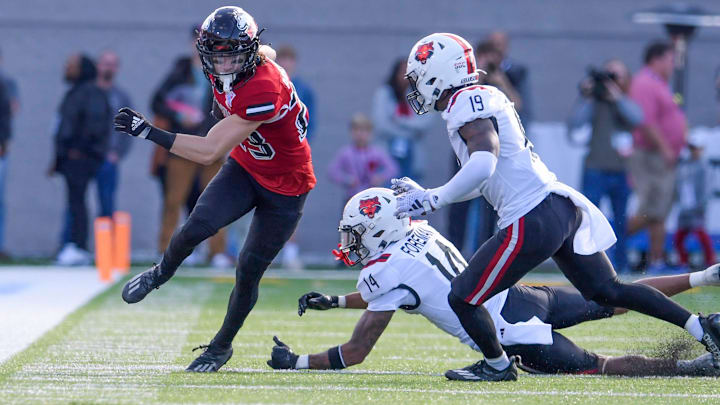 Northern Illinois Huskies wide receiver Dane Pardridge (23) eludes Arkansas State Red Wolves defensive back Denzel Blackwell (14) and defensive back James Reed III (19) in the Camellia Bowl at Cramton Bowl in Montgomery, Ala., on Saturday December 23, 2023. Northern Illinois Huskies wide receiver Dane Pardridge (23) eludes Arkansas State Red Wolves defensive back Denzel Blackwell (14) and defensive back James Reed III (19) in the Camellia Bowl at Cramton Bowl in Montgomery, Ala., on Saturday December 23, 2023.