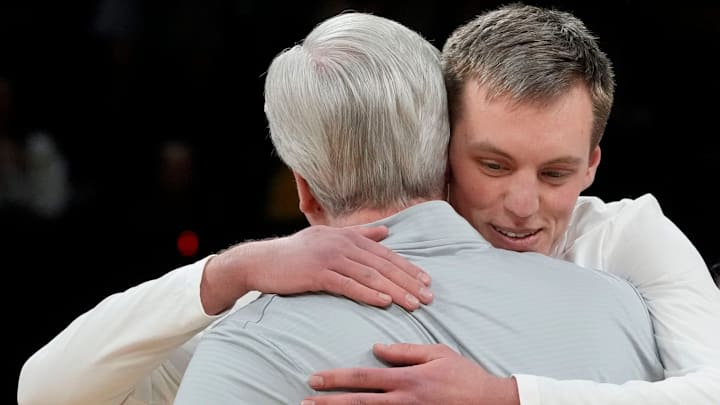 Iowa forward Payton Sandfort (20) hugs Iowa head coach Fran McCaffery during senior recognition ahead of a Big Ten Conference game against the Michigan State Spartans Thursday, March 6, 2025 at Carver-Hawkeye Arena in Iowa City.