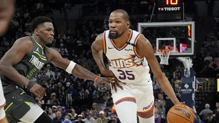 Mar 28, 2025; Minneapolis, Minnesota, USA; Phoenix Suns forward Kevin Durant (35) brings the ball up as Minnesota Timberwolves guard Anthony Edwards (5) defends him in the fourth quarter at Target Center. Mandatory Credit: Bruce Kluckhohn-Imagn Images