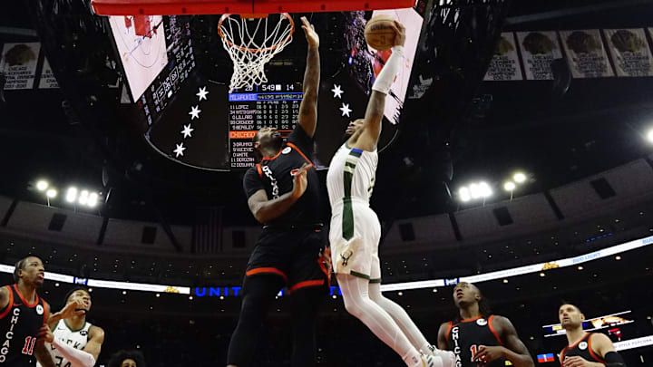 Mar 1, 2024; Chicago, Illinois, USA; Chicago Bulls center Andre Drummond (3) defends Milwaukee Bucks guard Damian Lillard (0) during the first quarter at United Center. Mandatory Credit: 