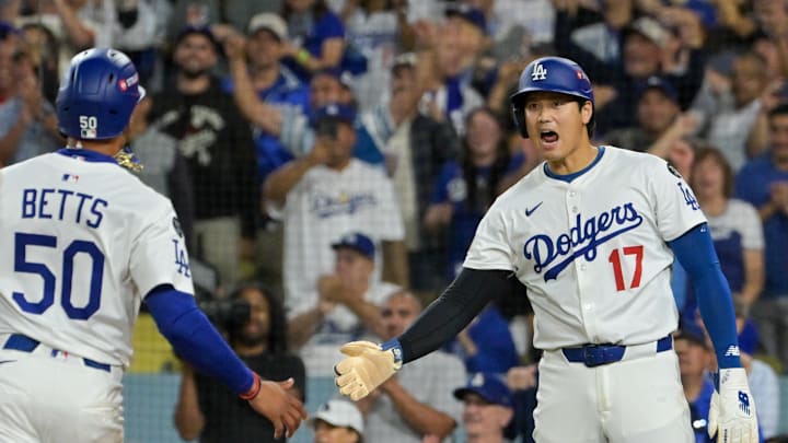Oct 1, 2025; Los Angeles, California, USA; Los Angeles Dodgers shortstop Mookie Betts (50) and designated hitter Shohei Ohtani (17) celebrate after scoring against the Cincinnati Reds in the sixth inning during game two of the Wildcard round for the 2025 MLB playoffs at Dodger Stadium. Mandatory Credit: Jayne Kamin-Oncea-Imagn Images Oct 1, 2025; Los Angeles, California, USA; Los Angeles Dodgers shortstop Mookie Betts (50) and designated hitter Shohei Ohtani (17) celebrate after scoring against the Cincinnati Reds in the sixth inning during game two of the Wildcard round for the 2025 MLB playoffs at Dodger Stadium. Mandatory Credit: Jayne Kamin-Oncea-Imagn Images
