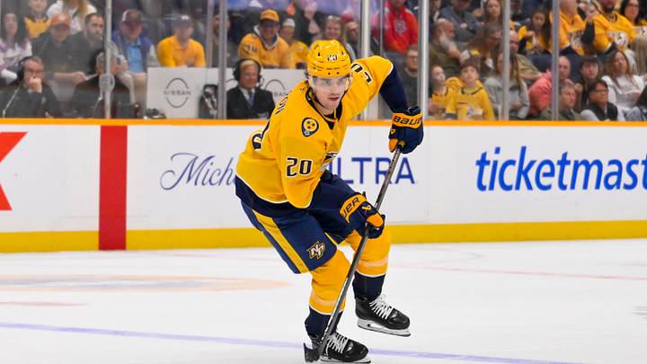 Mar 28, 2026; Nashville, Tennessee, USA;  Nashville Predators defenseman Justin Barron (20) skates with the puck against the Montreal Canadiens during the third period Gat Bridgestone Arena. Mandatory Credit: Steve Roberts-Imagn Images