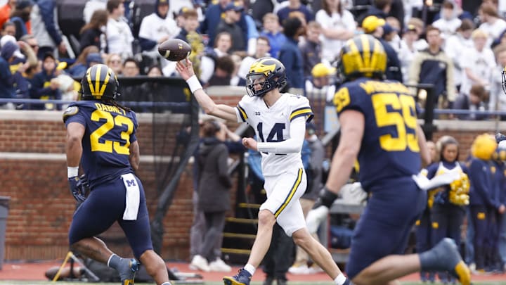 Apr 18, 2026; Ann Arbor, MI, USA; Michigan Wolverines quarterback Tommy Carr (14) passes the ball during the second half at Michigan Stadium. Mandatory Credit: Brian Bradshaw Sevald-Imagn Images