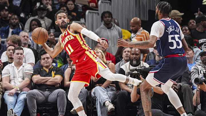 Mar 14, 2025; Atlanta, Georgia, USA; Atlanta Hawks guard Trae Young (11) passes against LA Clippers forward Derrick Jones Jr. (55) during the second half at State Farm Arena. Mandatory Credit: Dale Zanine-Imagn Images