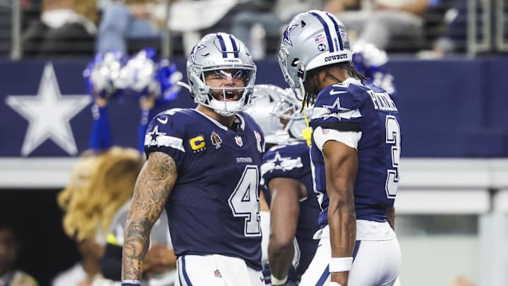 Dallas Cowboys quarterback Dak Prescott (4) celebrates with wide receiver George Pickens (3) following a touchdown pass caught by Pickens during the second quarter at AT&T Stadium.