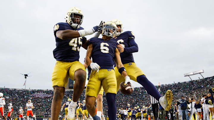 Notre Dame defensive lineman Kobi Onyiuke (45), wide receiver Jordan Faison (6) and wide receiver Alex Whitman (86) celebrate a Faison touchdown on fake punt play that would later be called back during a NCAA college football game against Virginia at Notre Dame Stadium on Saturday, Nov. 16, 2024, in South Bend.