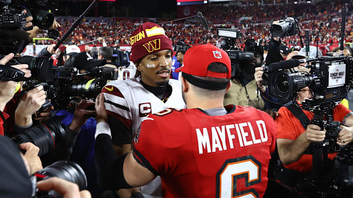 Jan 12, 2025; Tampa, Florida, USA; Washington Commanders quarterback Jayden Daniels (5) greets Tampa Bay Buccaneers quarterback Baker Mayfield (6) after winning a NFC wild card playoff at Raymond James Stadium. Mandatory Credit: Kim Klement Neitzel-Imagn Images