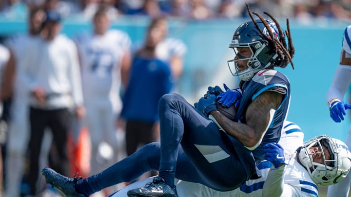 Tennessee Titans wide receiver DeAndre Hopkins (10) is tackled after a catch by Indianapolis Colts cornerback Jaylon Jones (40) during the first half of their game at Nissan Stadium in Nashville, Tenn., Monday, Oct. 14, 2024.