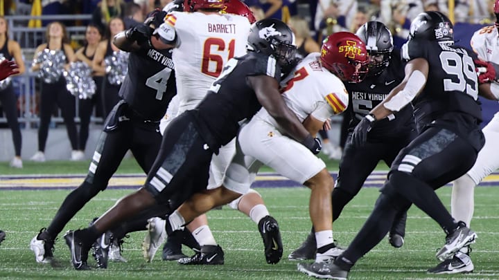 West Virginia University defensive lineman Asani Redwood sacks Iowa State quarterback Rocco Becht.