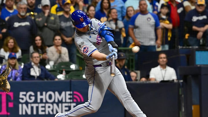 Oct 3, 2024; Milwaukee, Wisconsin, USA; New York Mets first baseman Pete Alonso (20) hits a three run home run against the Milwaukee Brewers in the ninth inning during game three of the Wildcard round for the 2024 MLB Playoffs at American Family Field.