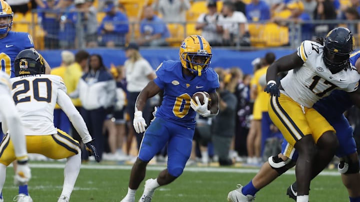 Oct 12, 2024; Pittsburgh, Pennsylvania, USA;  Pittsburgh Panthers running back Desmond Reid (0) runs the ball against the California Golden Bears during the third quarter at Acrisure Stadium. Pittsburgh won 17-15. Mandatory Credit: Charles LeClaire-Imagn Images
