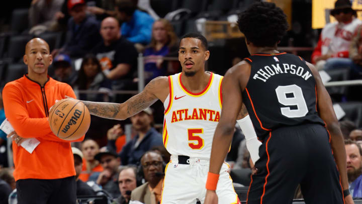 Nov 14, 2023; Detroit, Michigan, USA;  Atlanta Hawks guard Dejounte Murray (5) dribbles defended by Detroit Pistons forward Ausar Thompson (9) at Little Caesars Arena. Mandatory Credit: Rick Osentoski-USA TODAY Sports