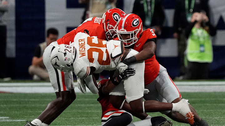 Georgia linebacker CJ Allen (3) takes down Texas running back Quintrevion Wisner (26) during the first half of the SEC championship game against Texas in Atlanta, on Saturday, Dec. 7, 2024.