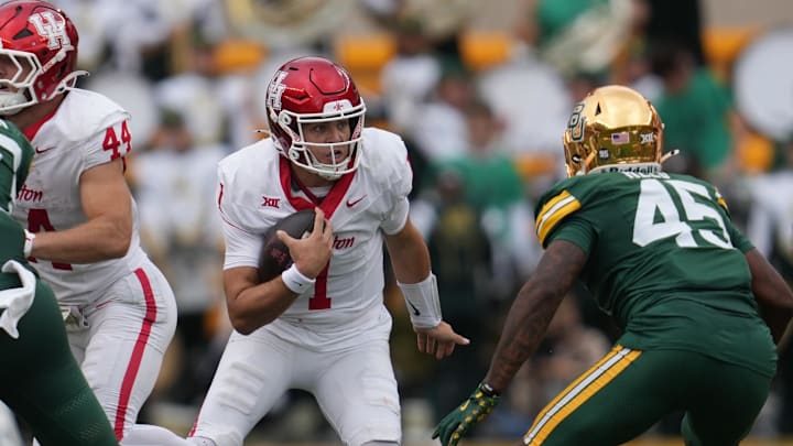 Nov 29, 2025; Waco, Texas, USA;  Houston Cougars quarterback Conner Weigman (1) carries the ball against Baylor Bears linebacker Kyland Reed (45) during the second half at McLane Stadium. Mandatory Credit: Chris Jones-Imagn Images