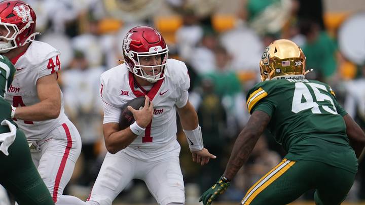 Nov 29, 2025; Waco, Texas, USA; Houston Cougars quarterback Conner Weigman (1) carries the ball against Baylor Bears linebacker Kyland Reed (45) during the second half at McLane Stadium. Mandatory Credit: Chris Jones-Imagn Images Nov 29, 2025; Waco, Texas, USA; Houston Cougars quarterback Conner Weigman (1) carries the ball against Baylor Bears linebacker Kyland Reed (45) during the second half at McLane Stadium. Mandatory Credit: Chris Jones-Imagn Images
