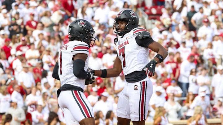 Oct 19, 2024; Norman, Oklahoma, USA; South Carolina Gamecocks defensive back Nick Emmanwori (7) celebrates with South Carolina Gamecocks defensive back DQ Smith (1)after making an interception during the first half against the Oklahoma Sooners at Gaylord Family-Oklahoma Memorial Stadium. 