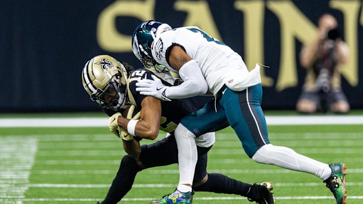 Sep 22, 2024; New Orleans, Louisiana, USA; New Orleans Saints wide receiver Chris Olave (12) is pushed out of bounds by Philadelphia Eagles cornerback Darius Slay Jr. (2) during the first half at Caesars Superdome. 