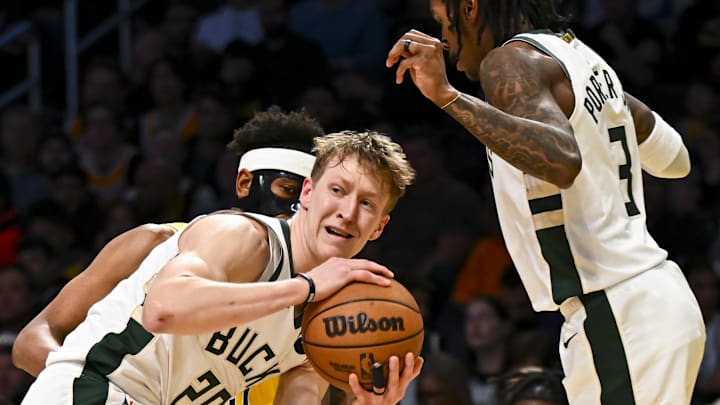Mar 20, 2025; Los Angeles, California, USA; Milwaukee Bucks guard AJ Green (20) looks to pass against Los Angeles Lakers guard Jordan Goodwin (30) during the second half at Crypto.com Arena. Mandatory Credit: Jonathan Hui-Imagn Images