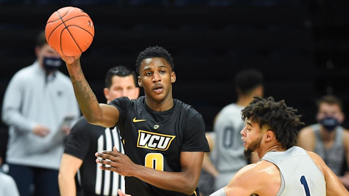 Dec 2, 2020; University Park, Pennsylvania, USA; Virginia Commonwealth Rams forward Jamir Watkins (0) passes the ball as Penn State Nittany Lions forward Seth Lundy (1) defends during the first half at the Bryce Jordan Center. Mandatory Credit: Rich Barnes-Imagn Images