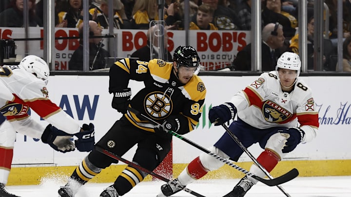 Mar 11, 2025; Boston, Massachusetts, USA; Boston Bruins center Jakub Lauko (94) cuts past Florida Panthers center Nico Sturm (8) during the second period at TD Garden. Mandatory Credit: Winslow Townson-Imagn Images