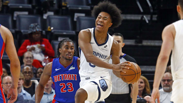 Oct 6, 2025; Memphis, Tennessee, USA; Memphis Grizzlies forward Jaylen Wells (0) drives to the basket as Detroit Pistons guard Jaden Ivey (23) defends during the first quarter at FedExForum. Mandatory Credit: Petre Thomas-Imagn Images