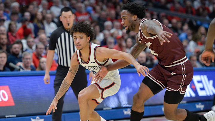 Feb 17, 2024; Dayton, Ohio, USA;  Dayton Flyers guard Javon Bennett (0) battles against Fordham forward Romad Dean (2) during the game at University of Dayton Arena. Mandatory Credit: Matt Lunsford-Imagn Images