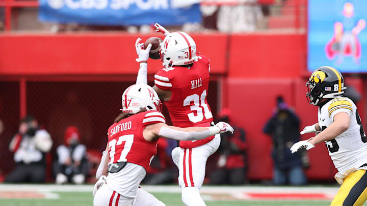 Nov 24, 2023; Lincoln, Nebraska, USA; Nebraska Cornhuskers defensive back Tommi Hill intercepts a pass intended for Iowa Hawkeyes wide receiver Nico Ragaini (89) at Memorial Stadium.