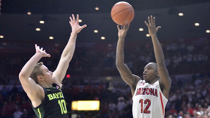 Dec 15, 2018; Tucson, AZ, USA; Arizona Wildcats guard Justin Coleman (12) shoots as Baylor Bears guard Makai Mason (10) defends during the second half at McKale Center. Mandatory Credit: Casey Sapio-Imagn Images
