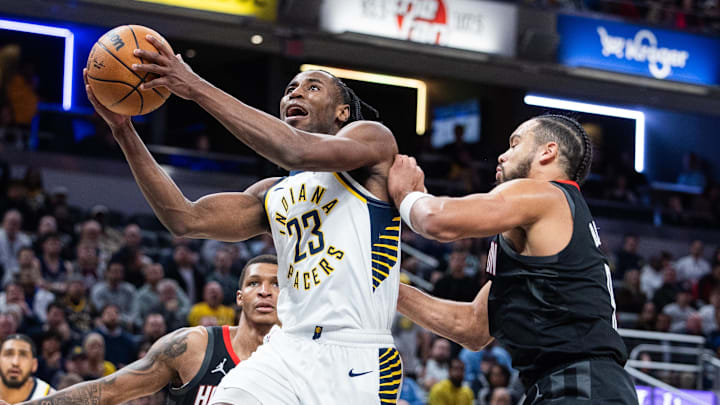 Mar 4, 2025; Indianapolis, Indiana, USA; Indiana Pacers forward Aaron Nesmith (23) shoots the ball while Houston Rockets forward Dillon Brooks (9)  defends in the second half at Gainbridge Fieldhouse. Mandatory Credit: Trevor Ruszkowski-Imagn Images