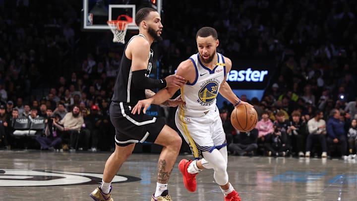 Mar 6, 2025; Brooklyn, New York, USA;  Golden State Warriors guard Stephen Curry (30) drives past Brooklyn Nets guard Tyrese Martin (13) in the first quarter at Barclays Center. Mandatory Credit: Wendell Cruz-Imagn Images