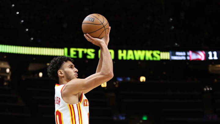 Dec 21, 2024; Atlanta, Georgia, USA; Atlanta Hawks forward Zaccharie Risacher (10) shoots the ball against the Memphis Grizzlies during the first half at State Farm Arena. Mandatory Credit: Jordan Godfree-Imagn Images