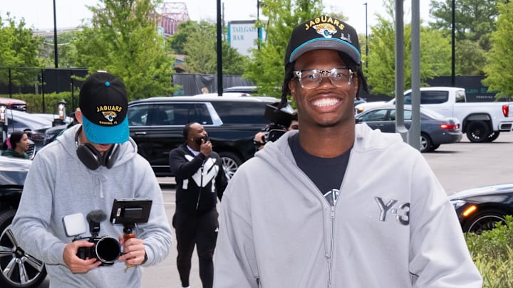 The Jacksonville Jaguars first-round pick, Colorado Buffaloes wide receiver and defensive back Travis Hunter, right, was all smiles as he arrived on Friday, March 25, 2025 at Miller Electric Center in Jacksonville, Fla. The team traded up from fifth to second after making a deal with the Cleveland Browns on Thursday night. The Jaguars held a press conference to introduce the rookie with general manager James Gladstone and head coach Liam Coen and Jaguars owner Shahid Khan. [Doug Engle/Florida