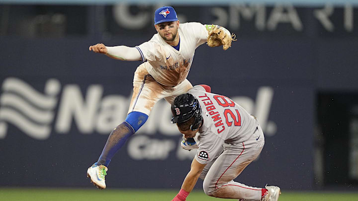 Apr 29, 2025; Toronto, Ontario, CAN; Toronto Blue Jays shortstop Bo Bichette (11) collides with Boston Red Sox second baseman Kristian Campbell (28) after turning a double play at second base and at first base against first baseman Triston Casas (not pictured) to end the fifth inning at Rogers Centre. Mandatory Credit: John E. Sokolowski-Imagn Images