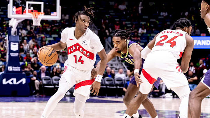 Nov 27, 2024; New Orleans, Louisiana, USA;  Toronto Raptors guard Ja'Kobe Walter (14) dribbles against New Orleans Pelicans guard Antonio Reeves (12) during the second half at Smoothie King Center. Mandatory Credit: Stephen Lew-Imagn Images