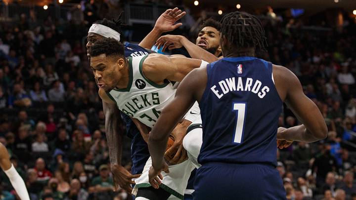 Oct 27, 2021; Milwaukee, Wisconsin, USA; Milwaukee Bucks forward Giannis Antetokounmpo (34) grabs the ball between Minnesota Timberwolves forward Jarred Vanderbilt (8) and guard Anthony Edwards (1) during the third quarter at Fiserv Forum. Mandatory Credit: Jeff Hanisch-Imagn Images Oct 27, 2021; Milwaukee, Wisconsin, USA; Milwaukee Bucks forward Giannis Antetokounmpo (34) grabs the ball between Minnesota Timberwolves forward Jarred Vanderbilt (8) and guard Anthony Edwards (1) during the third quarter at Fiserv Forum. Mandatory Credit: Jeff Hanisch-Imagn Images