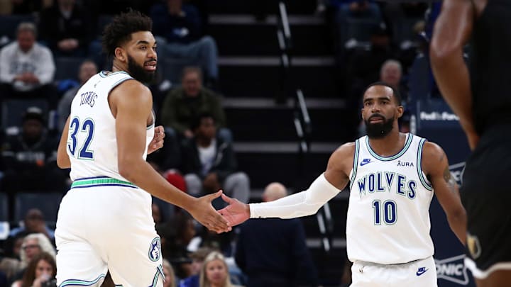 Dec 8, 2023; Memphis, Tennessee, USA; Minnesota Timberwolves center-forward Karl-Anthony Towns (32) reacts with guard Mike Conley (10) during the first half against the Memphis Grizzlies  at FedExForum. Mandatory Credit: Petre Thomas-Imagn Images