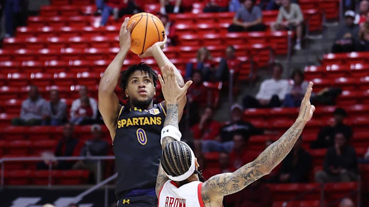 Nov 3, 2025; Salt Lake City, Utah, USA; San Jose State Spartans guard Colby Garland (0) shoots over Utah Utes guard Terrence Brown (2) during the first half at Jon M. Huntsman Center. Mandatory Credit: Rob Gray-Imagn Images