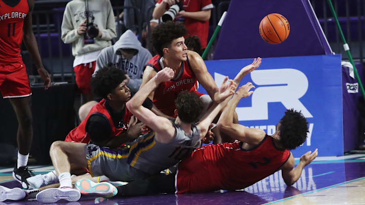 Players for the Miami Columbus High School basketball fight for the ball against Montverde during the championship game against at the City of Palms Classic at Suncoast Credit Union Arena in Fort Myers on Monday, Dec. 23, 2024. Players for the Miami Columbus High School basketball fight for the ball against Montverde during the championship game against at the City of Palms Classic at Suncoast Credit Union Arena in Fort Myers on Monday, Dec. 23, 2024.