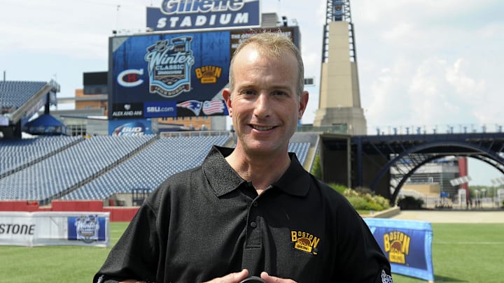 Jul 29, 2015; Foxboro, MA, USA; Boston Bruins CEO Charlie Jacobs poses with a Winter Classic puck during a press conference for the Winter Classic hockey game at Gillette Stadium. Mandatory Credit: Bob DeChiara-Imagn Images