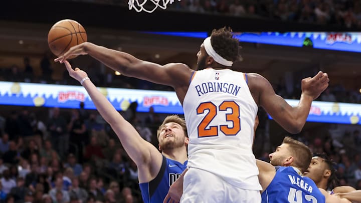 Mar 9, 2022; Dallas, Texas, USA;  New York Knicks center Mitchell Robinson (23) blocks the shot of Dallas Mavericks guard Luka Doncic (77) during the second quarter at American Airlines Center. Mandatory Credit: Kevin Jairaj-Imagn Images